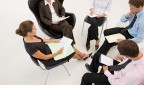 Five office workers in a meeting